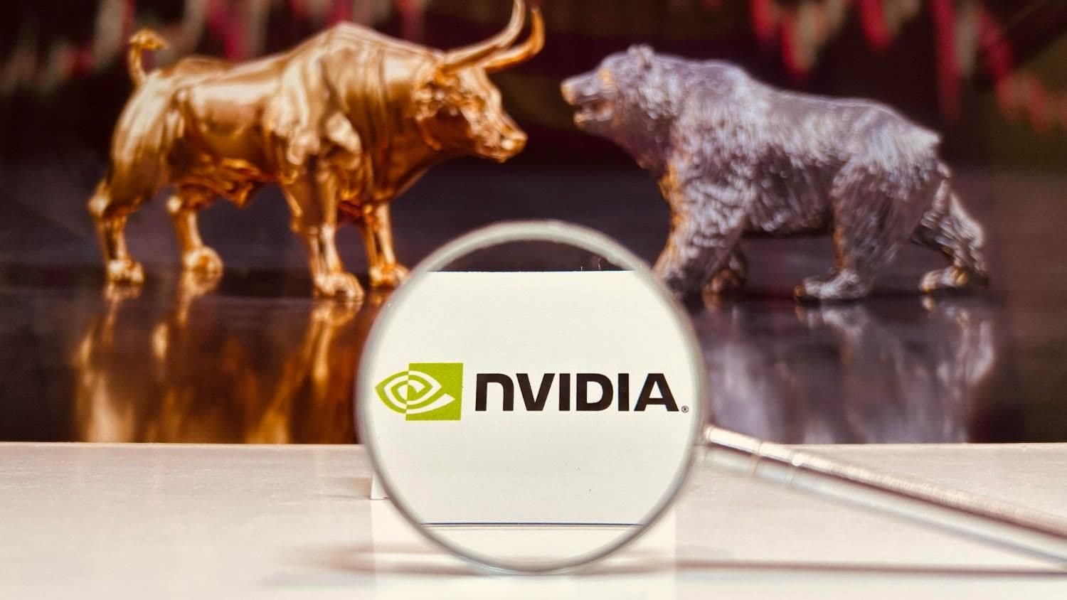 Nvidia chief executive Jensen Huang speaks onstage beside a screen displaying the company's stock price chart